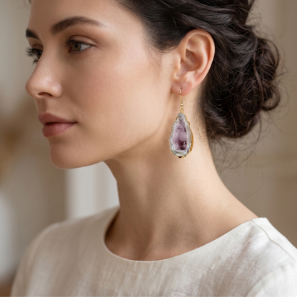 Side profile close-up of a model wearing a silver-plated edge agate geode earring, showcasing the sparkling crystal center.